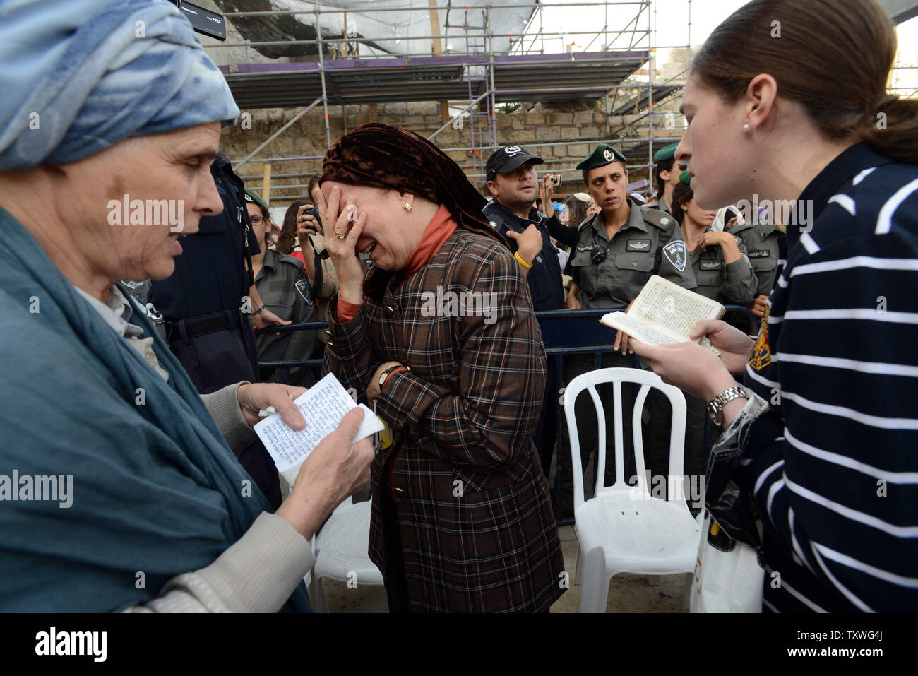 Ultra-Orthodox Jewish women pray and weep in a protest against members of the progressive Jewish organization Women of the Wall, while they pray wearing traditional religious items used only by men, at