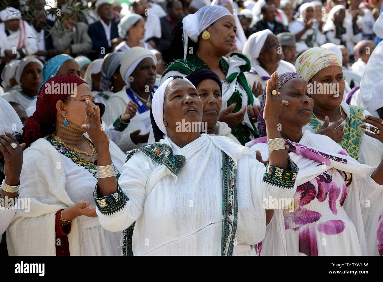 Ethiopian Jewish women pray during the Sigd holiday on a hill overlooking Jerusalem, October 31, 2013. The Sigd holiday use to mark the desire of Ethiopian Jews to return to Zion, while today thousands of Ethiopians gather  to pray and rejoice for their return to Jerusalem and  the renewal of the alliance between God, the people and the Torah.   UPI/Debbie Hill Stock Photo