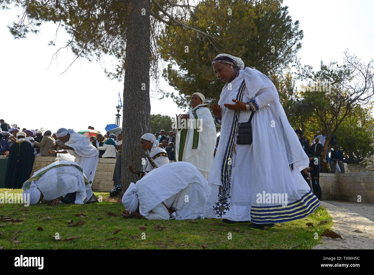 Ethiopian Jewish women pray during the Sigd holiday on a hill overlooking Jerusalem, October 31, 2013. The Sigd holiday use to mark the desire of Ethiopian Jews to return to Zion, while today thousands of Ethiopians gather  to pray and rejoice for their return to Jerusalem and  the renewal of the alliance between God, the people and the Torah.   UPI/Debbie Hill Stock Photo