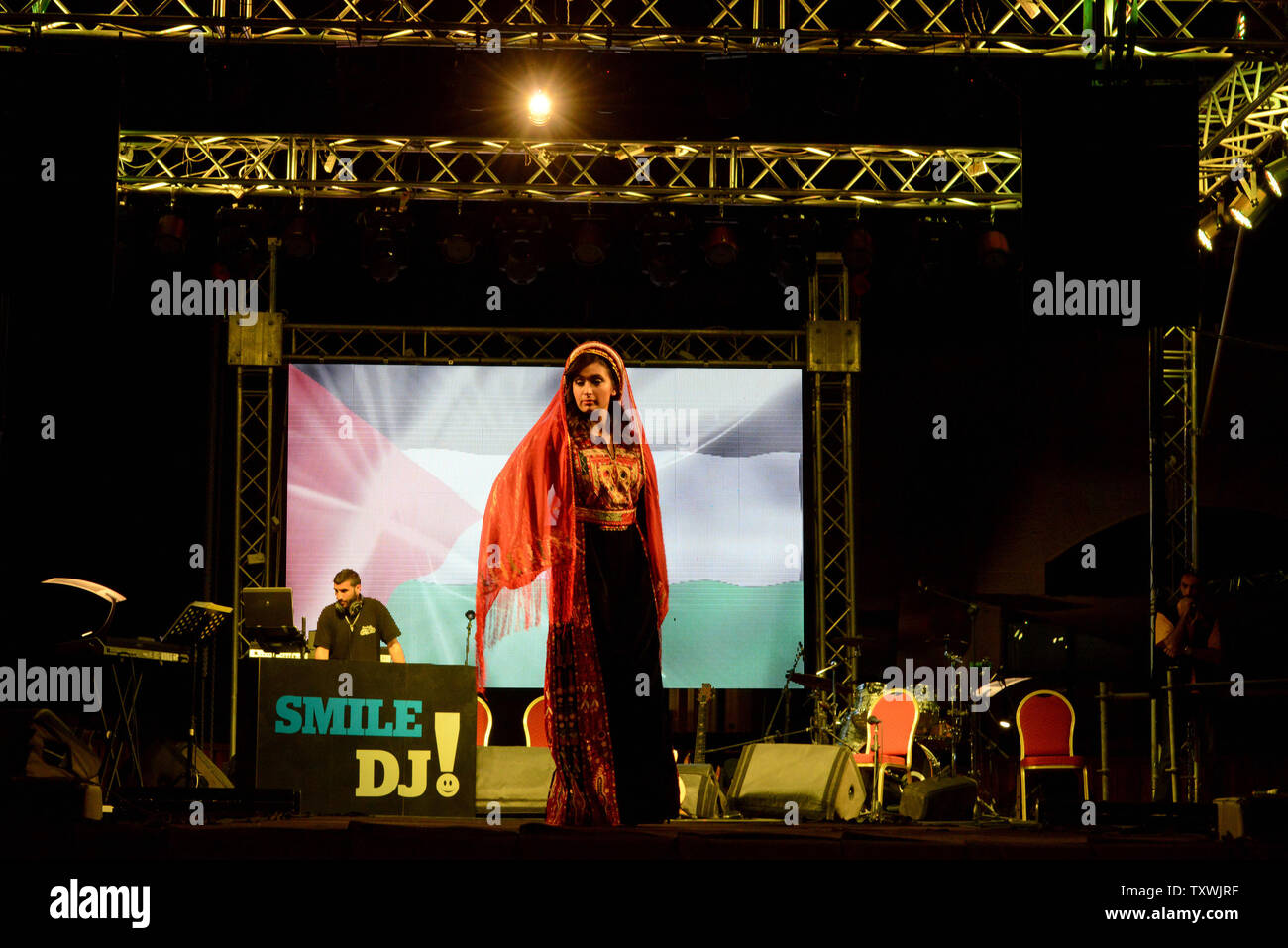 A Palestinian model wears a traditional dress by Palestinian designer