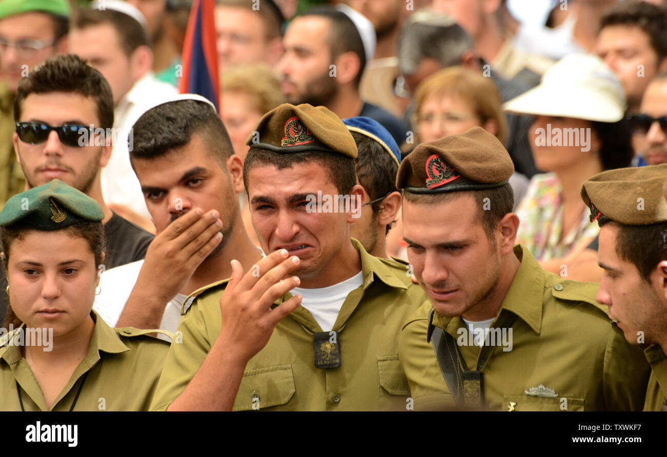 Israeli soldiers weep during the funeral of American-Israeli soldier Max Steinberg, 24, in the military cemetery on Mt. Herzl in Jerusalem, Israel, July 23, 2014.  Steinberg, a native of Los Angeles, California, immigrated to Israel and enlisted in the Israel Defense Forces in 2012, where he served as a sharpshooter in the elite Golani Brigade. He was among the 13 soldiers killed by Palestinian militants in the Gaza Strip on Sunday. Twenty-nine Israeli troops have been killed since the army launched a ground incursion into Gaza last week. More than 30,000 people attended the funeral. UPI/Debbi Stock Photo