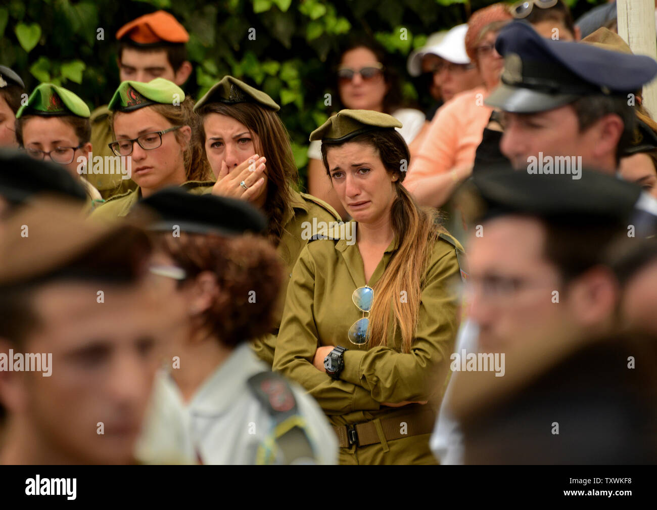 Israeli soldiers weep during the funeral of American-Israeli soldier Max Steinberg, 24, in the military cemetery on Mt. Herzl in Jerusalem, Israel, July 23, 2014.  Steinberg, a native of Los Angeles, California, immigrated to Israel and enlisted in the Israel Defense Forces in 2012, where he served as a sharpshooter in the elite Golani Brigade. He was among the 13 soldiers killed by Palestinian militants in the Gaza Strip on Sunday. Twenty-nine Israeli troops have been killed since the army launched a ground incursion into Gaza last week. More than 30,000 people attended the funeral. UPI/Debbi Stock Photo