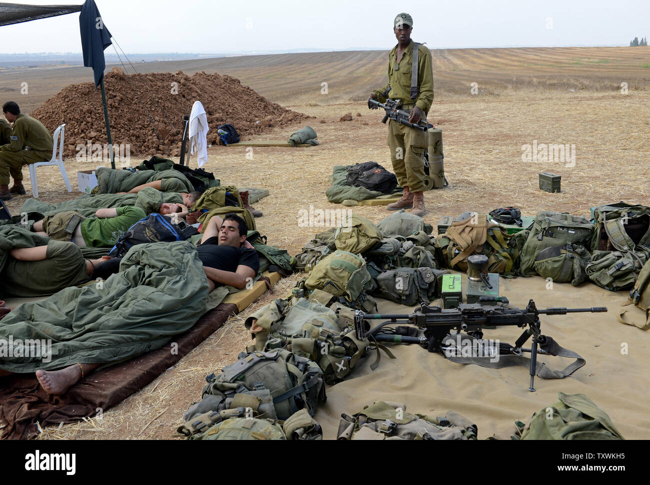 Israeli soldiers sleep at a staging area at an unspecified  location near the Israeli border with the Gaza Strip in southern Israel,  July 28, 2014.  Fighting between Israel and Hamas was quieter on the first day of the Muslim holiday of Eid Al Fitr, after pressure from the UN Security Council and US President Barak Obama for an immediate ceasefire.  UPI/Debbie Hill Stock Photo