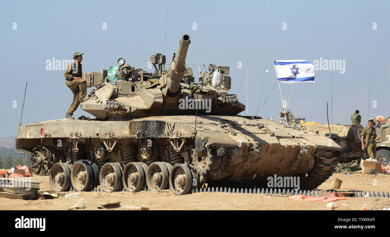Israeli soldiers work on a Merkava tank at a staging area near the Israel and Hamas controlled Gaza Strip border in southern Israel, July 31, 2014.   UPI/Debbie Hill Stock Photo