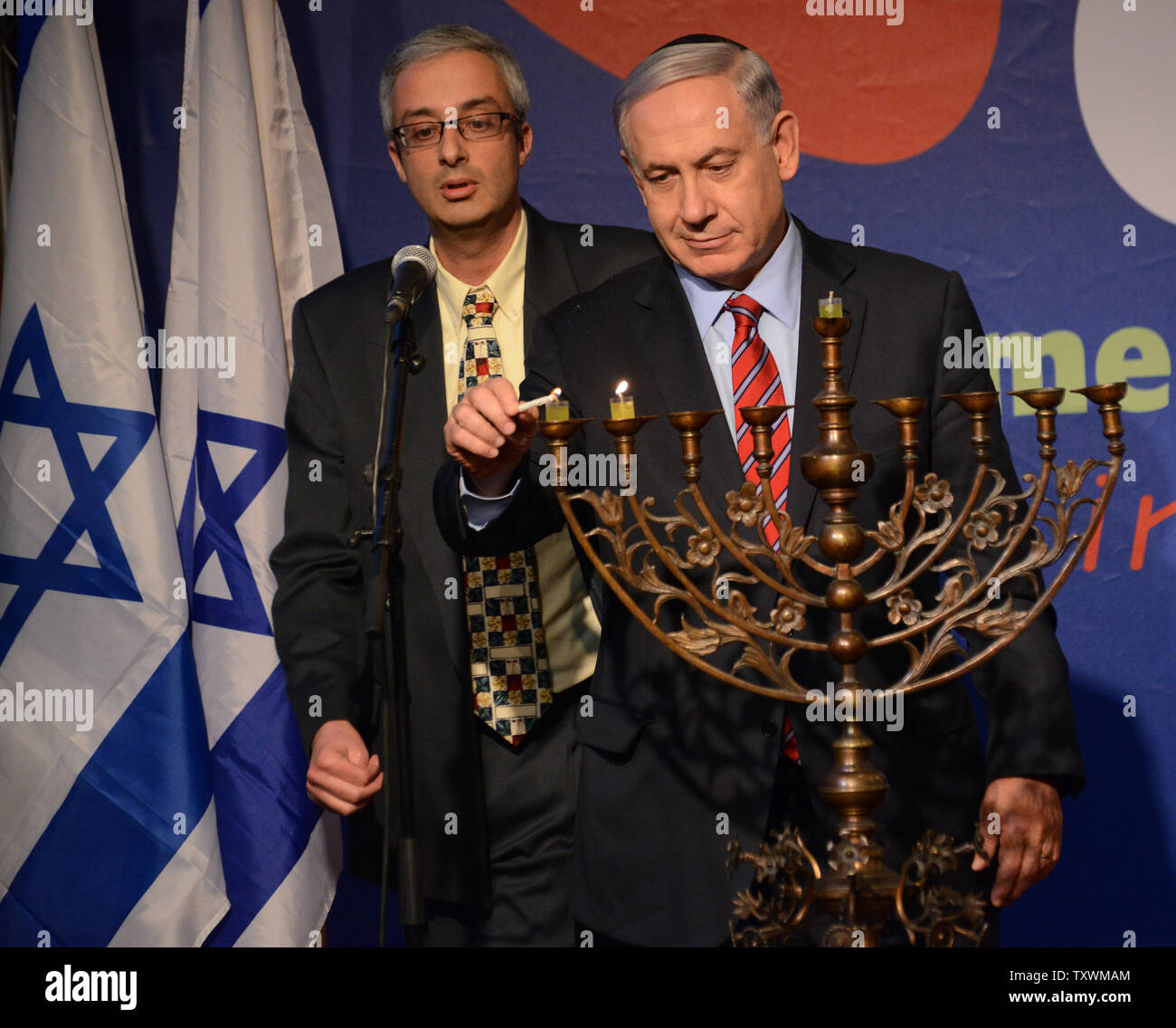 Israeli Prime Minister Benjamin Netanyahu lights candles on a menorah, on the second night of Hanukkah, at an event with the foreign press at the Israeli Museum in Jerusalem, Israel, December 17, 2014. UPI/Debbie Hill Stock Photo