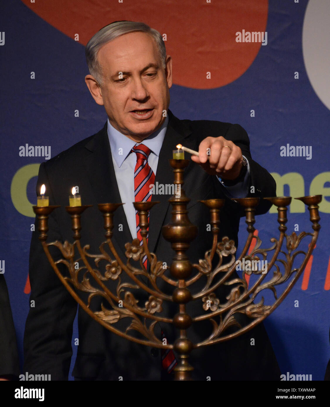 Israeli Prime Minister Benjamin Netanyahu lights candles on a menorah, on the second night of Hanukkah, at an event with the foreign press at the Israeli Museum in Jerusalem, Israel, December 17, 2014. UPI/Debbie Hill Stock Photo