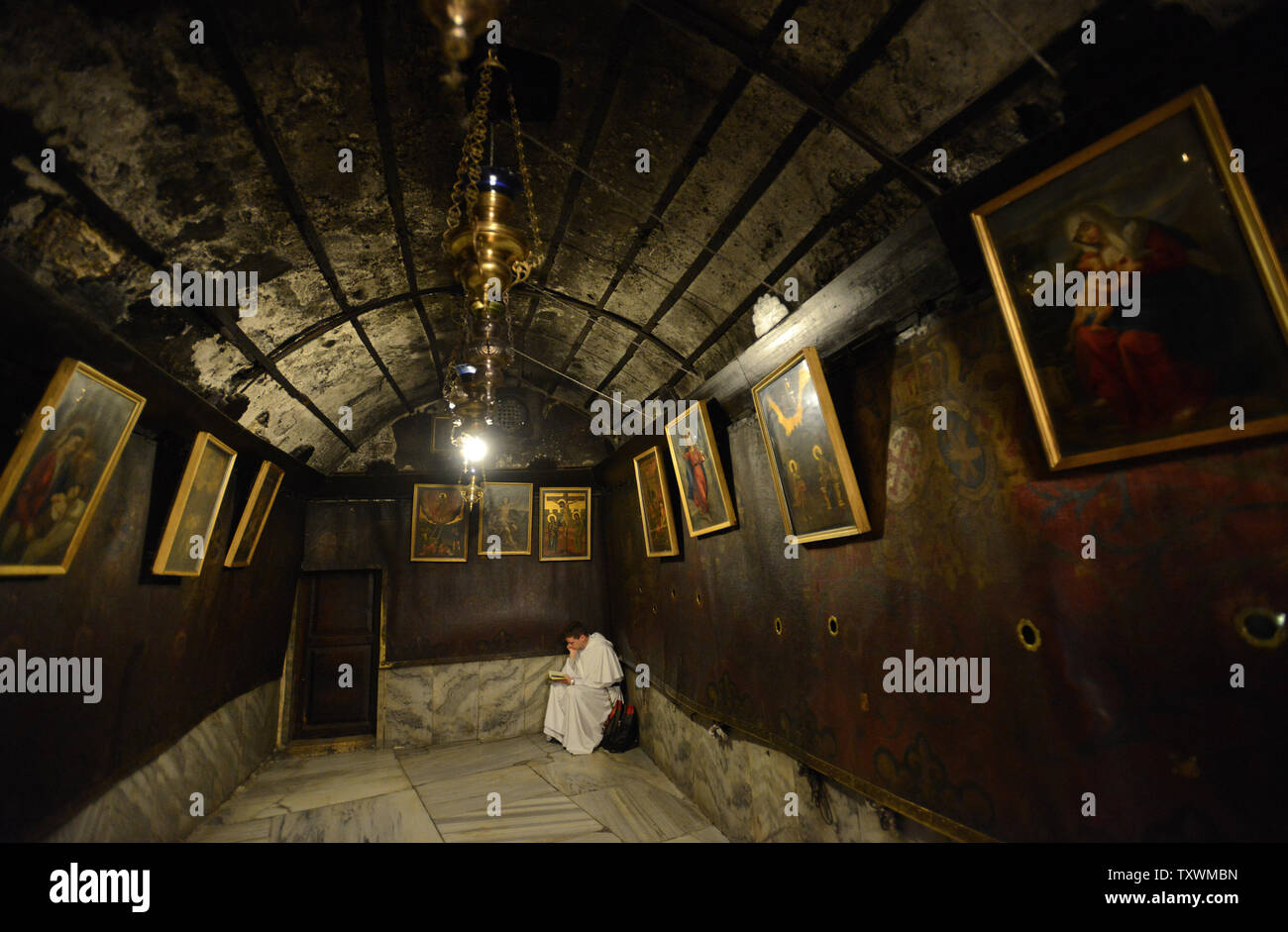 A priest prays in the grotto of the Church of the Nativity where tradition believes Jesus Christ