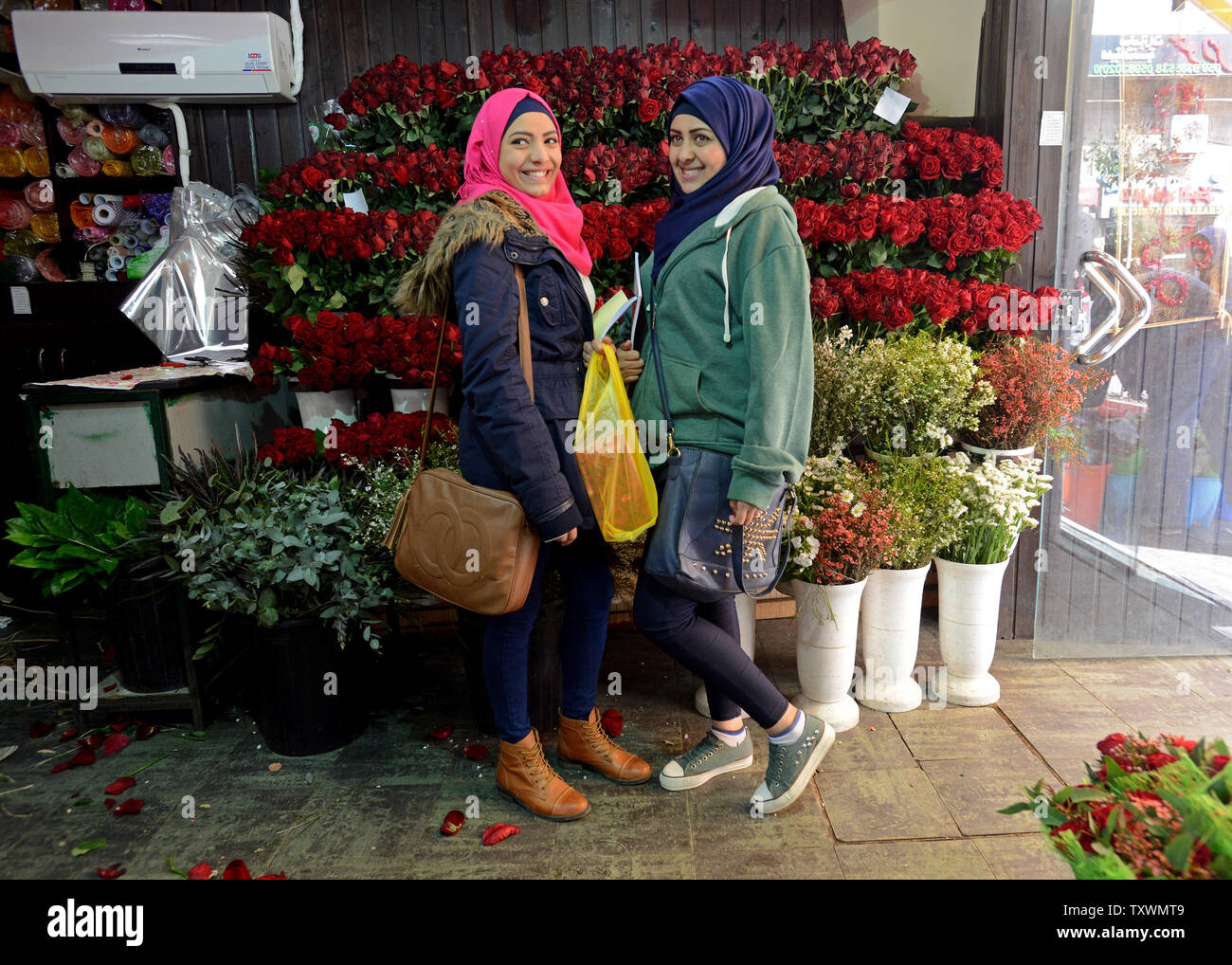 Palestinian Roses Palestinian teens pose in front of red roses on Valentine's Day in a ...