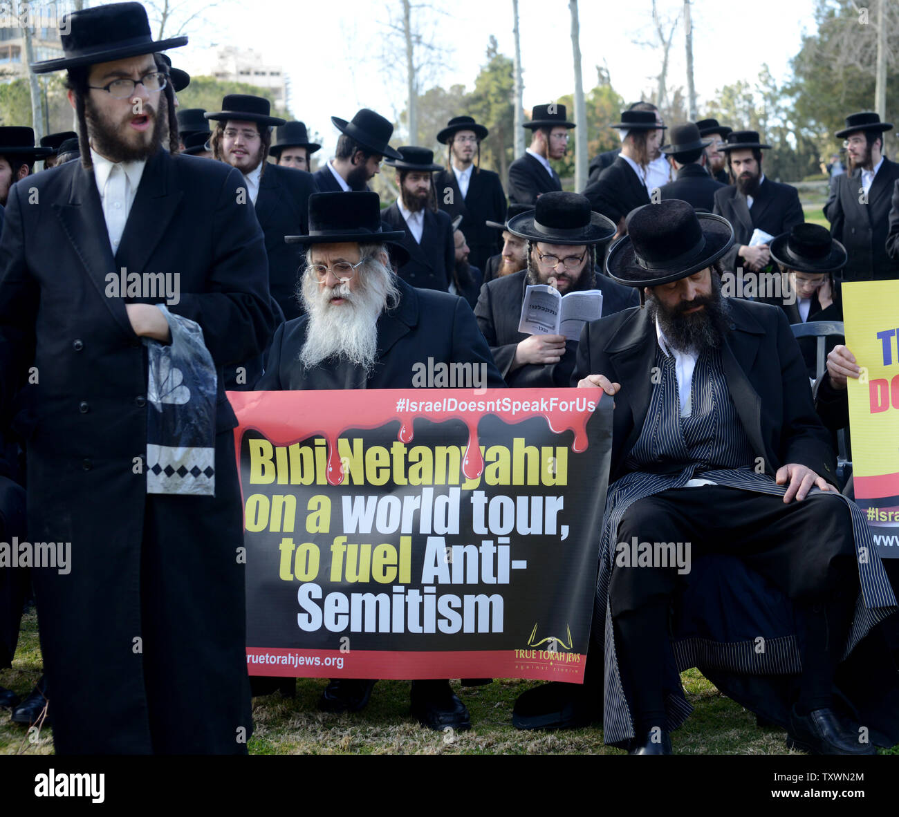 Ultra-Orthodox Jews from the Neturei Karta group hold a protest sign reading 'Bibi Netanyahu on a world tour to fuel Anti-Semitism', in front of the American Consulate in Jerusalem, Israel, to condemn today's speech by Israeli Prime Minister Benjamin Netanyahu to the US Congress, March 3, 2015.  Photo by Debbie Hill/UPI Stock Photo
