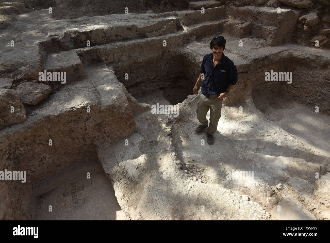 Archeologist Amit Reem shows an archeological site that has revealed a large mausoleum uncovered by the Israel Antiquities Authority while searching for the real location of the Tomb of the Maccabees in Modi'in, Israel, September 21, 2015.  Byzantine Period mosaics adorned with a cross were found in the floor of a burial vault believed to be associated with the Tombs of the Maccabees who were exalted saints in the eyes of early Christianity. The Maccabees led the uprising against Greek rule and were responsible for cleansing the impurity from the Second Temple. As yet, archaeological evidence Stock Photo