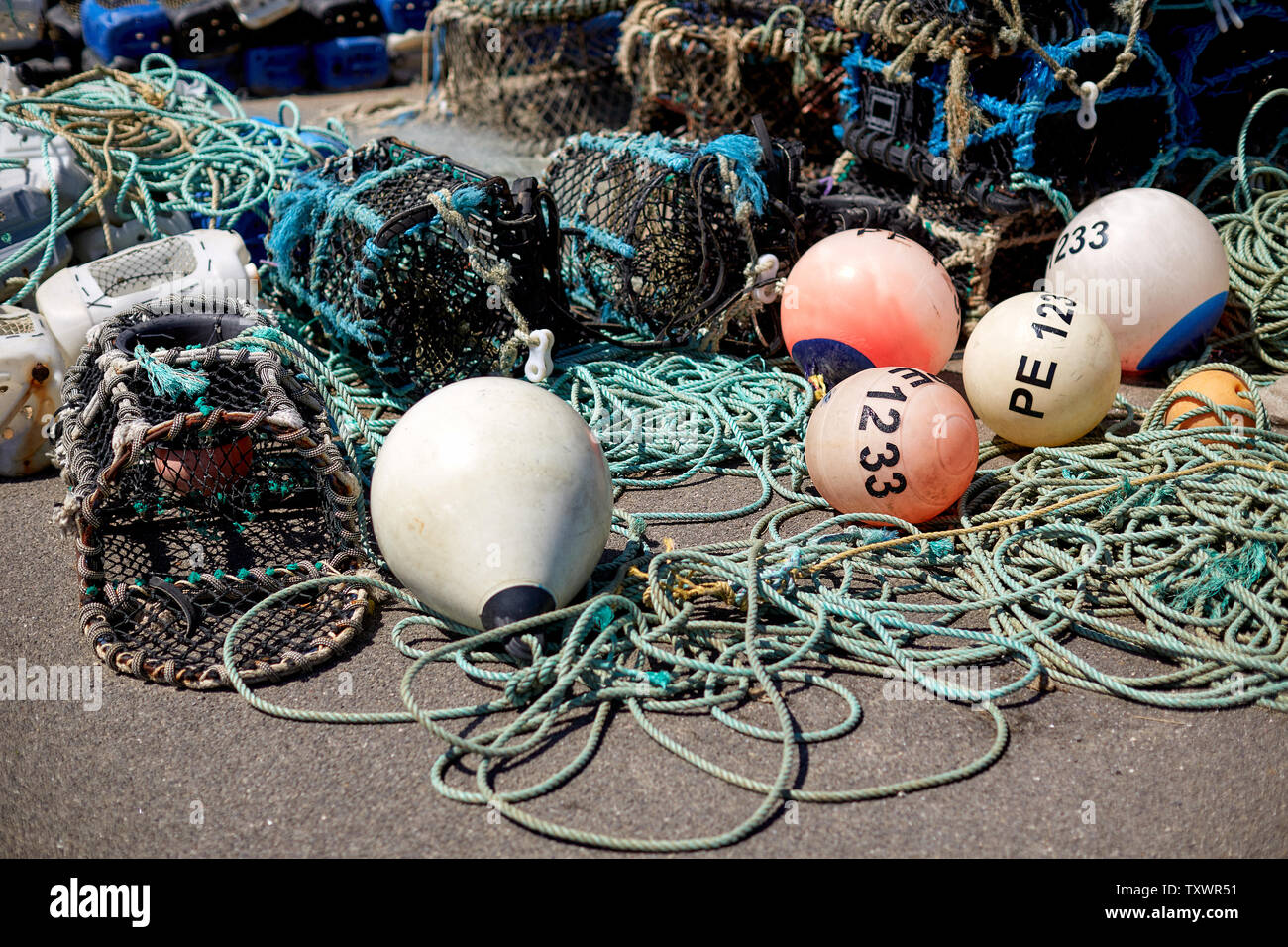 Fishing tackle and lobster pots on the harbour at Mudeford Quay, Dorset. Part of the British fishing industry. Stock Photo