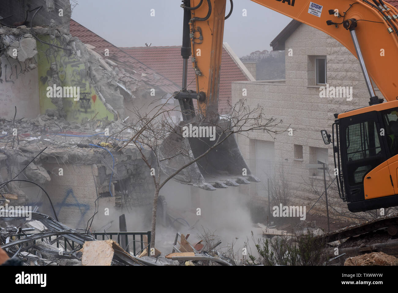 A bulldozer demolishes a Jewish house in the Ofra Settlement in the West Bank near Ramallah,  March 1, 2017. Israeli forces are demolishing nine Jewish homes in the Ofra Settlement after the Supreme Court ruled they were  built on private Palestinian land.  Photo by Debbie Hill/UPI Stock Photo