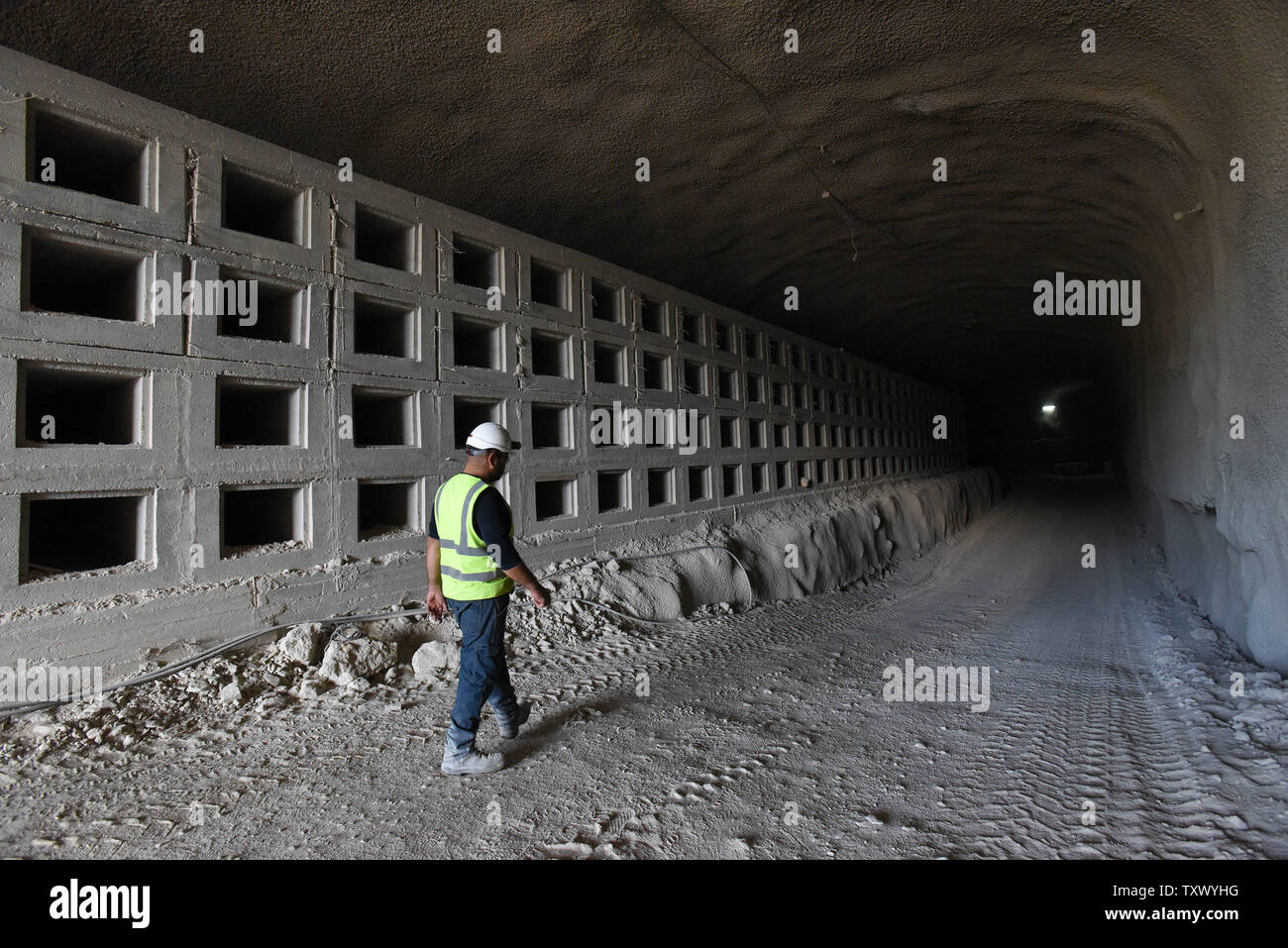 Itzik Behar, project engineer, walks past partially constructed  burial plots in the underground burial tunnels at the Givat Shaul Cemetery, Har HaMenuchot, in Jerusalem, Israel, November 26, 2017.  Due to overcrowding and lack of land for burial sites in Jerusalem, the religious burial society called Chevra Kadisha, is building the massive underground burial site that will provide space for more than 22,000 graves.   Photo by Debbie Hill/UPI Stock Photo