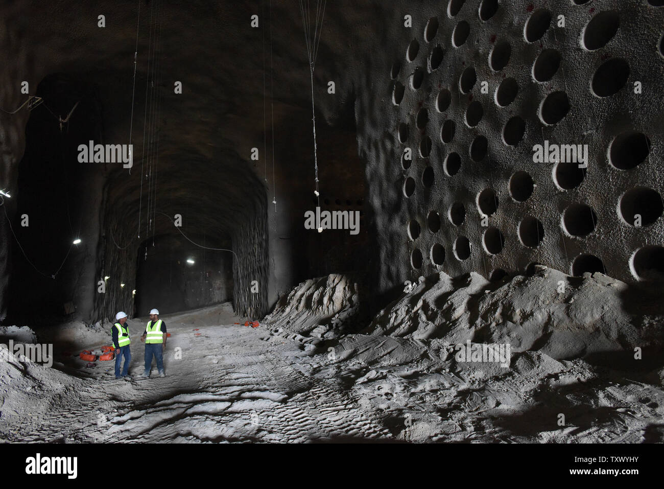 Israelis stand near partially constructed catacomb burial plots in the underground burial tunnels at the Givat Shaul Cemetery, Har HaMenuchot, in Jerusalem, Israel, November 26, 2017.  Due to overcrowding and lack of land for burial sites in Jerusalem, the religious burial society called Chevra Kadisha, is building the massive underground burial site that will provide space for more than 22,000 graves.   Photo by Debbie Hill/UPI Stock Photo