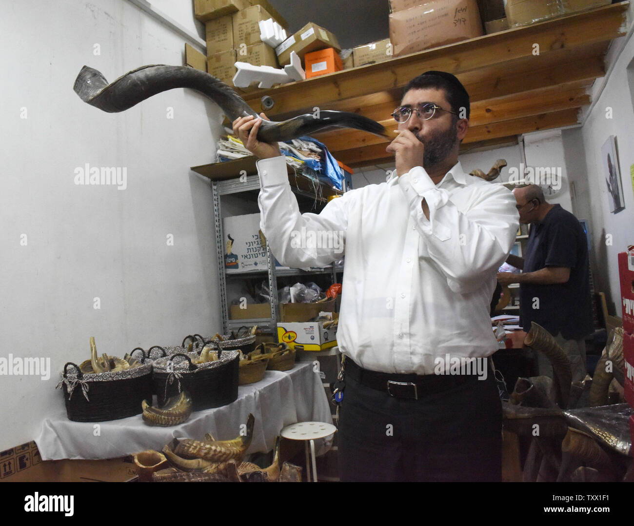 An Orthodox Jew tests a horn at the Ribak Shofar factory in Tel Aviv