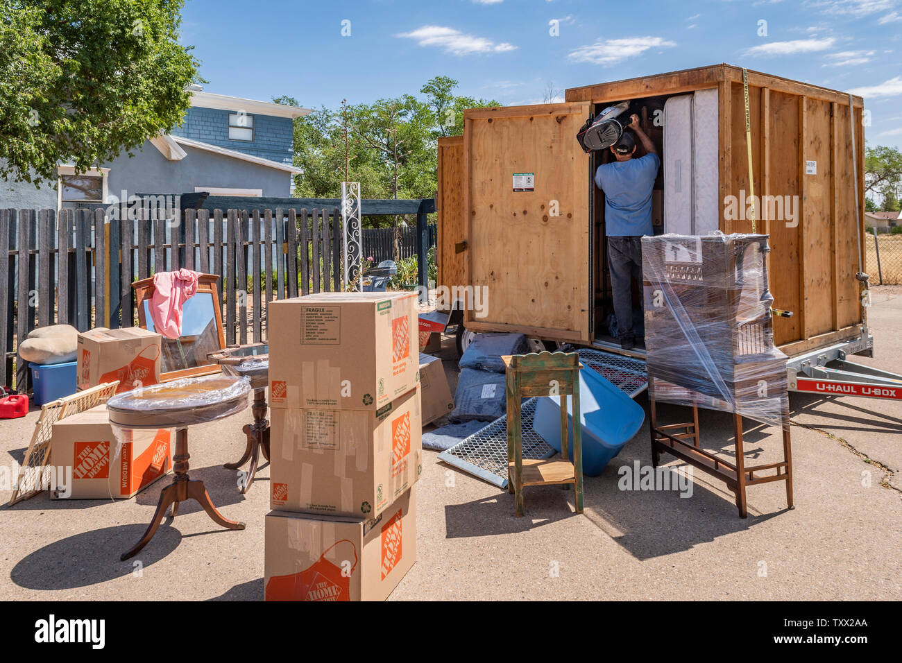 UHaul, UBox storage and shipping containers, furniture and household  packing in progress. Stock Photo