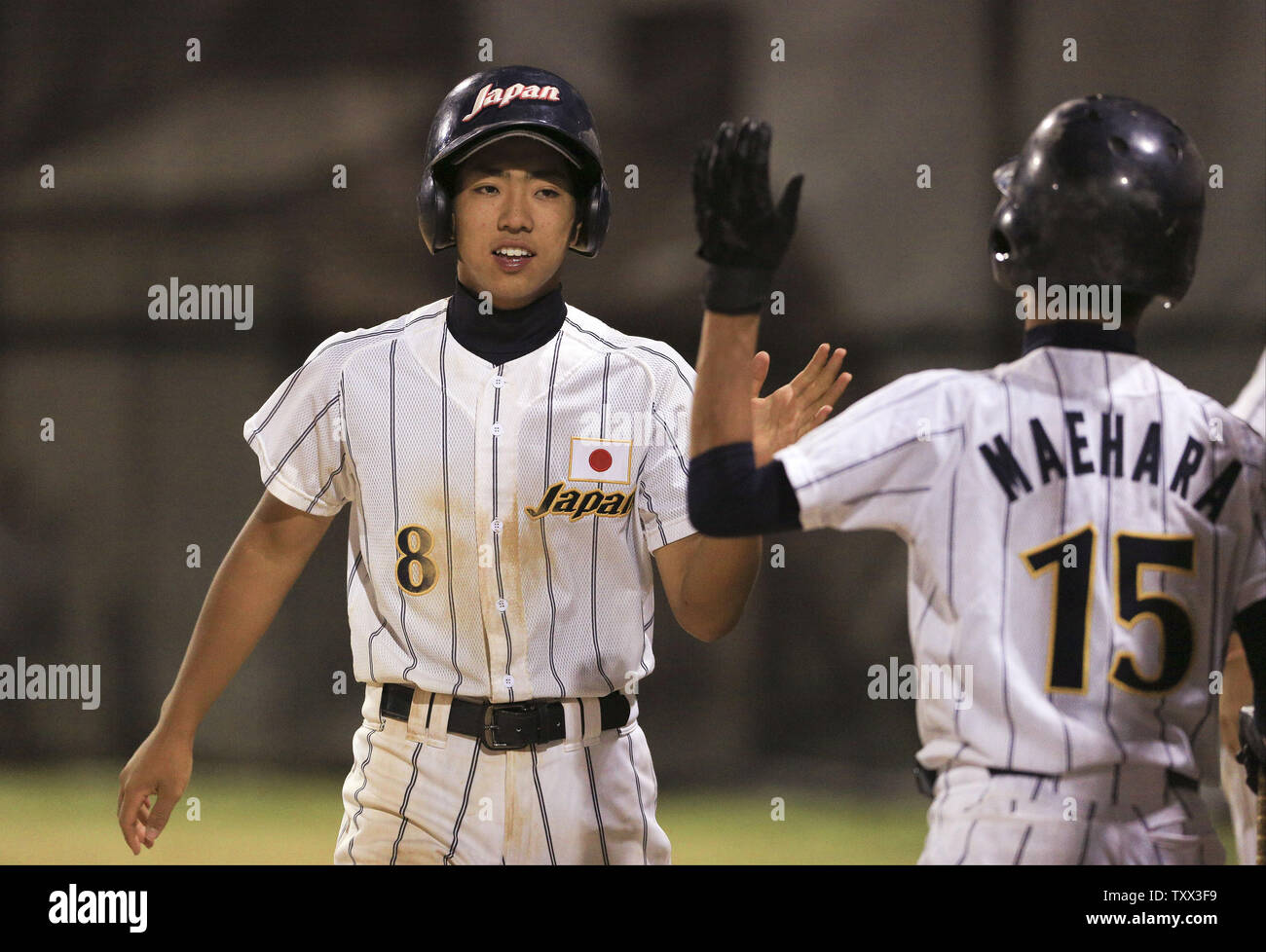 Japan's Kosei Katayama (L) is greeted by Kento Maehara after scoring in the fourth inning of their championship game against Los Lomas Potros during the McHenry County Youth Sports Association's 23rd annual 15-Year-Old International Baseball Tournament on August 1, 2015 in Crystal Lake, Illinois.  Japan defeated Los Lomas Potros 3-2. Photo by John Konstantaras/UPI Stock Photo