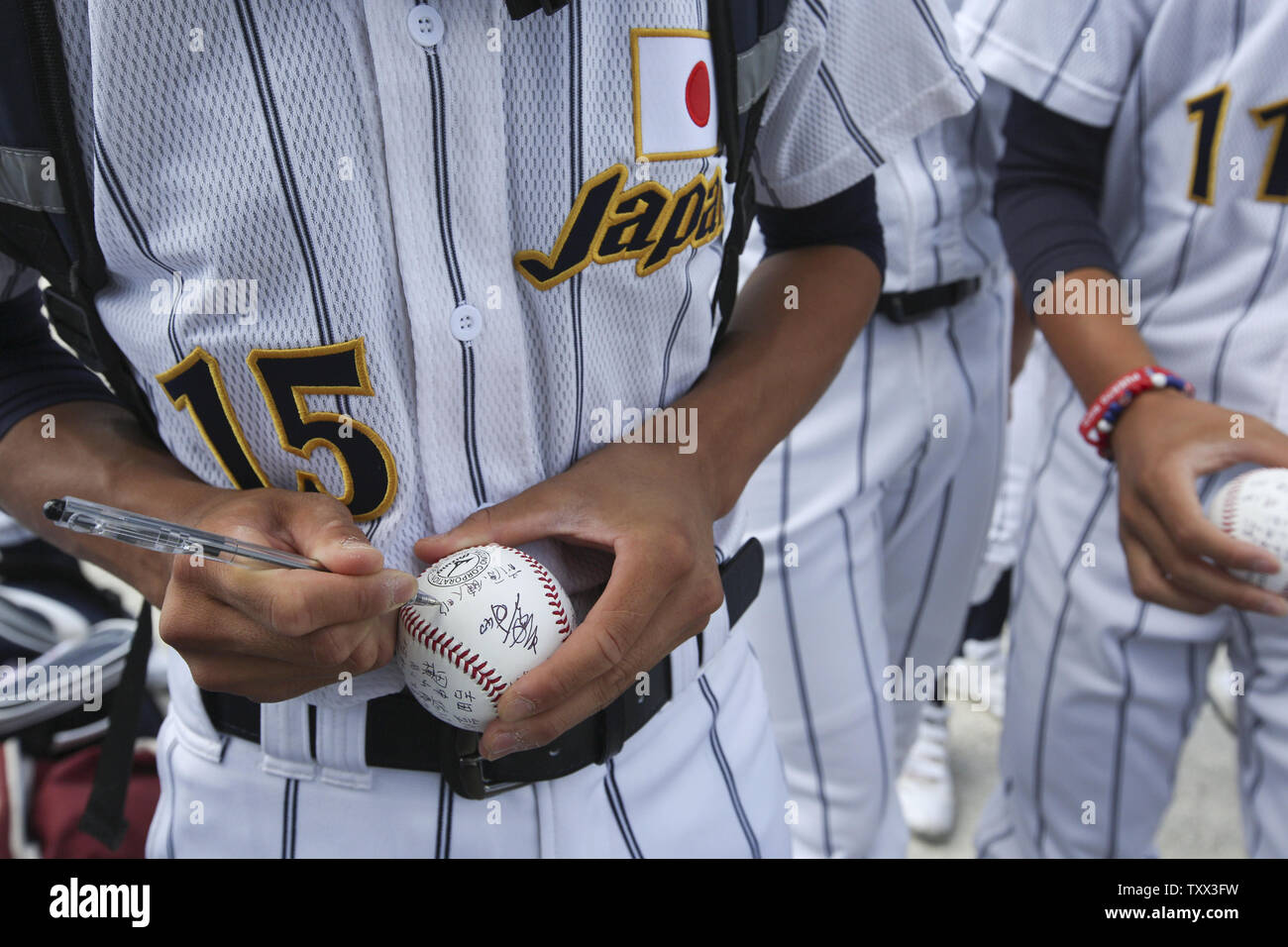 Japan's Kento Maehara autographs a ball before their first game against Los Lomas Potros for the McHenry County Youth Sports Association's 23rd annual 15-Year-Old International Championship on August 1, 2015 in Crystal Lake, Illinois.  Japan lost to Los Lomas Potros 6-4 in their first game but defeated them 3-2 in their second game to win the championship.. Photo by John Konstantaras/UPI Stock Photo