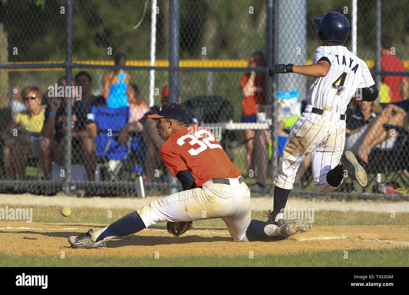 Japan's Ryuta Itaya (R) beats the throw to Los Lomas Potros first baseman Benjamin Negron (L) during the fourth inning of their first game of the McHenry County Youth Sports Association's 23rd annual 15-Year-Old International Championship on August 1, 2015 in Crystal Lake, Illinois.  Japan lost to Los Lomas Potros 6-4 in their first game but defeated them 3-2 in their second game to win the championship.. Photo by John Konstantaras/UPI Stock Photo
