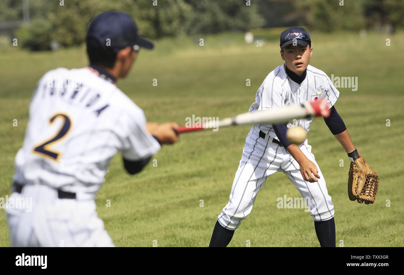 (L-R) Japan's Kai Yoshida and Yuya Tanaka warm up before their first game against Los Lomas Potros during the McHenry County Youth Sports Association's 23rd annual 15-Year-Old International Championship on August 1, 2015 in Crystal Lake, Illinois.  Japan lost to Los Lomas Potros 6-4 in their first game but defeated them 3-2 in their second game to win the championship.. Photo by John Konstantaras/UPI Stock Photo