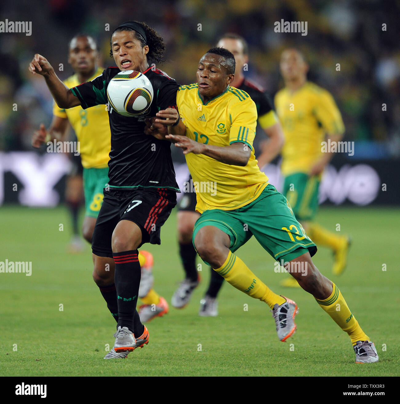Kagisho Dikgacoi of South Africa battles with Giovani Dos Santos of Mexico during the Group A match at Soccer City in Johannesburg, South Africa on June 11, 2010. UPI/Chris Brunskill Stock Photo