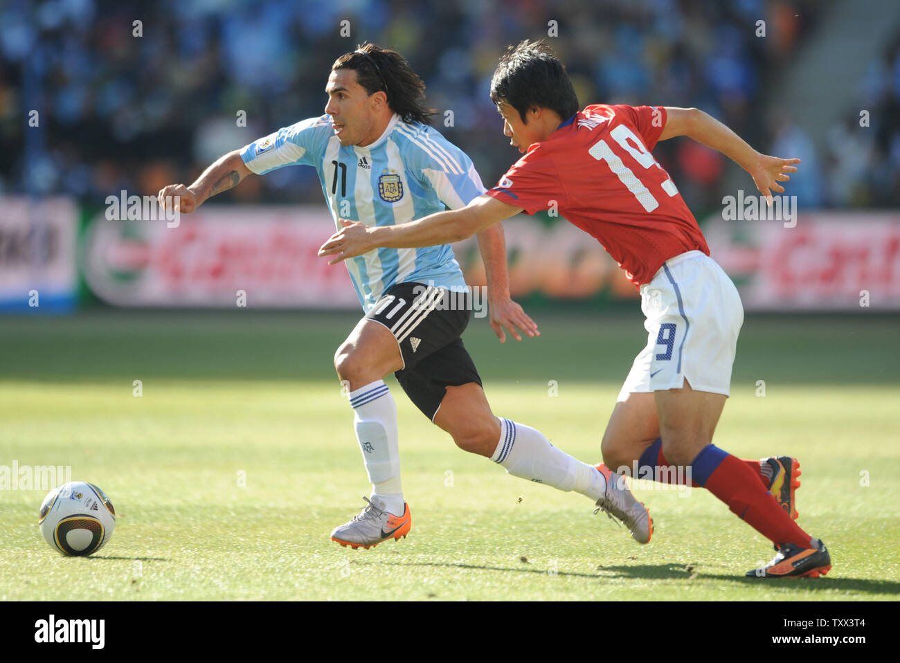 Carlos Tevez of Argentina and Yeom Ki Hun of South Korea during the Group B match at Soccer City Stadium in Johannesburg, South Africa on June 17, 2010. UPI/Chris Brunskill Stock Photo