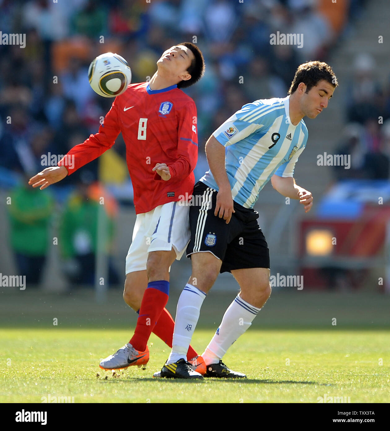 Gonzalo Higuain of Argentina and Kim Jung Woo of South Korea during the Group B match at Soccer City Stadium in Johannesburg, South Africa on June 17, 2010. UPI/Chris Brunskill Stock Photo