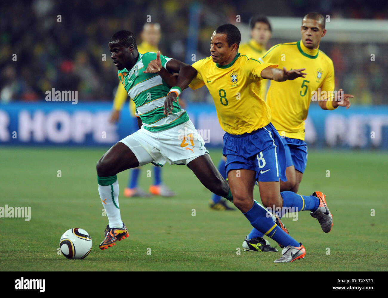 Gilberto Silva of Brazil and Emmanuel Eboue of Ivory Coast go after the ball during the Group G match at Soccer City Stadium in Johannesburg, South Africa on June 20, 2010. UPI/Chris Brunskill Stock Photo