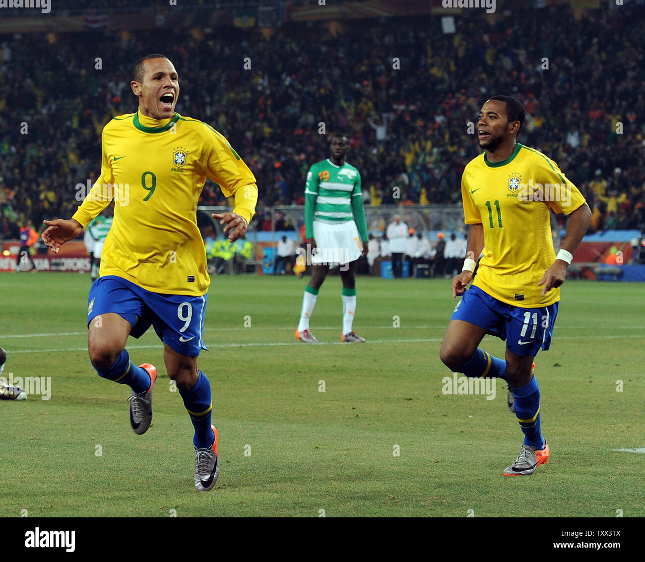 Luis Fabiano of Brazil celebrates scoring his side's second goal with team-mate Robinho during the Group G match at Soccer City Stadium in Johannesburg, South Africa on June 20, 2010. UPI/Chris Brunskill Stock Photo