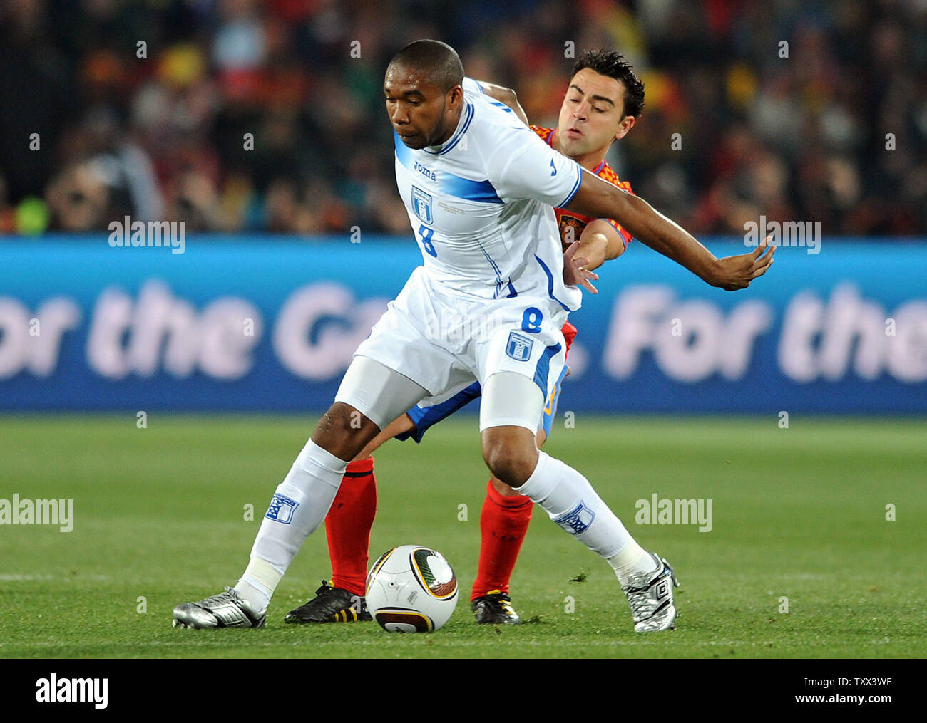 Xavi of Spain and Wilson Palacios of Honduras during the Group H match at Ellis Park in Johannesburg, South Africa on June 21, 2010. UPI/Chris Brunskill Stock Photo