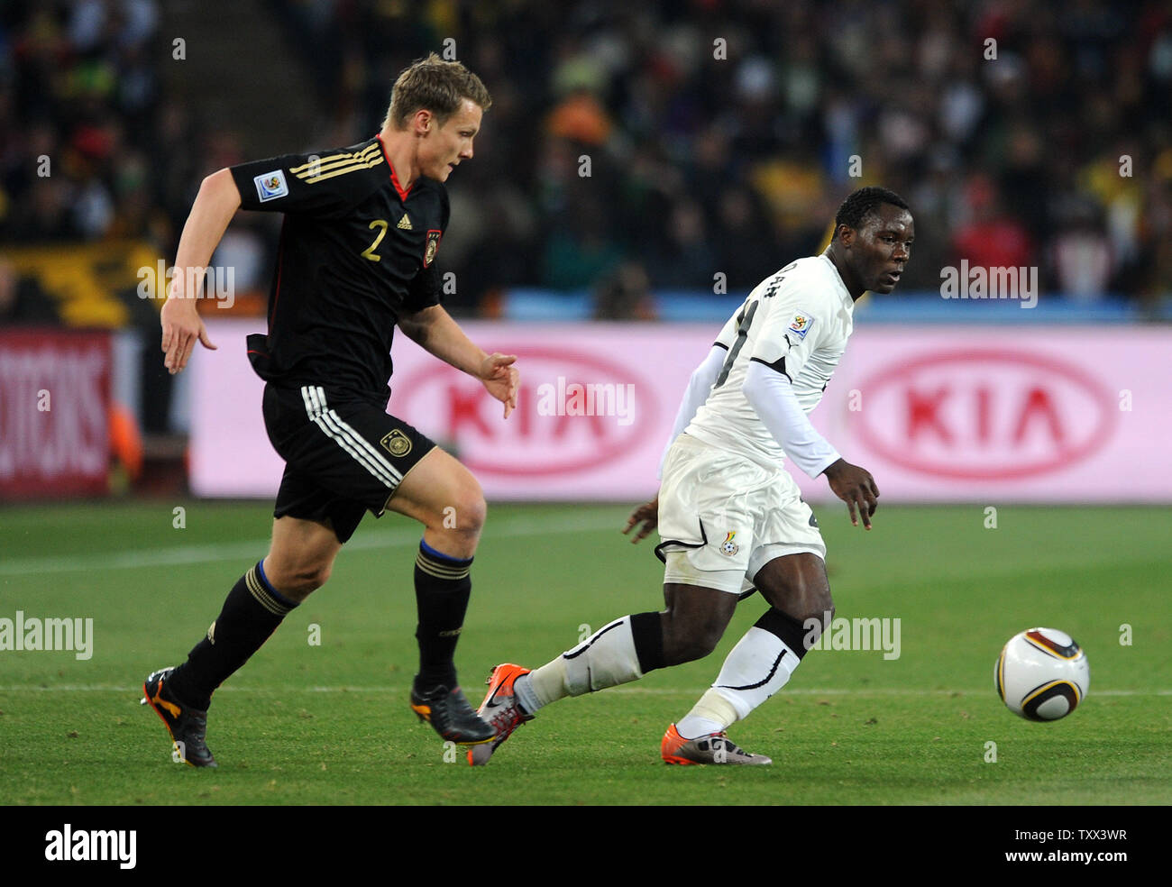 Kwadwo Asamoah of Ghana and Marcell Jansen of Germany go after the ball during the Group D match at Soccer City Stadium in Johannesburg, South Africa on June 23, 2010. UPI/Chris Brunskill Stock Photo