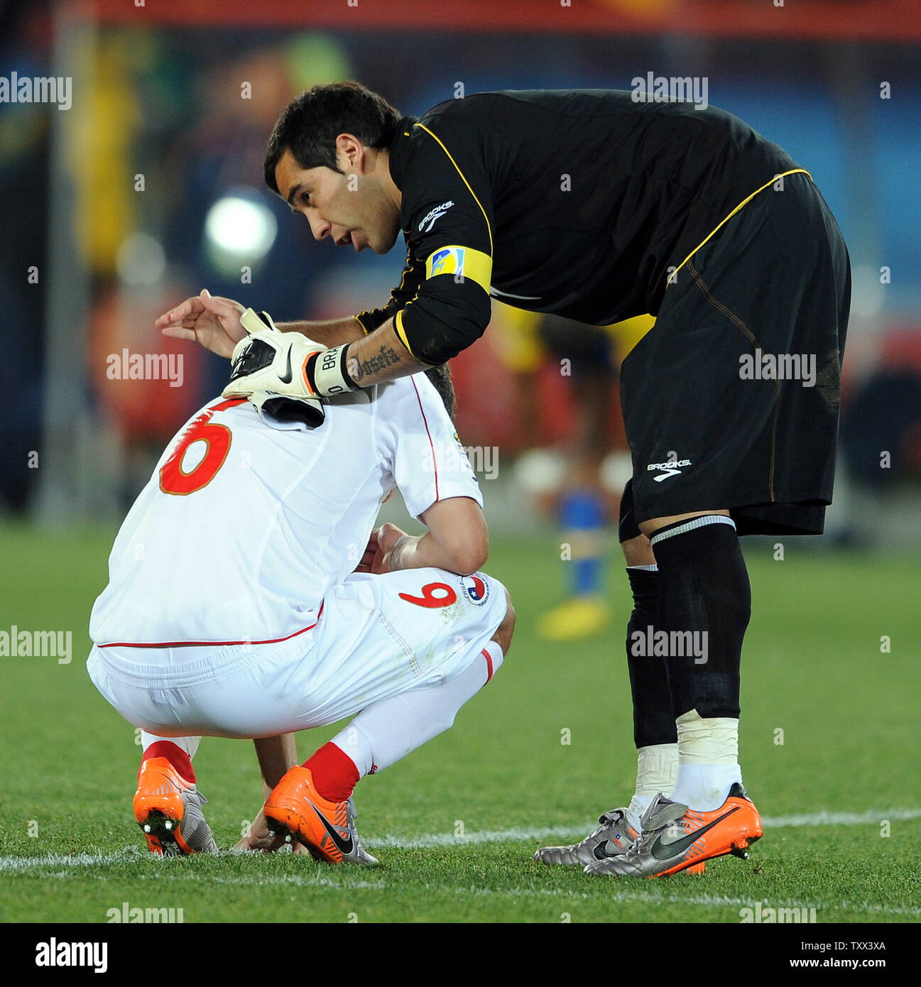 Carlos Carmona of Chile is consoled by team-mate Claudio Bravo at full-time after the FIFA World Cup Round of 16 match at Ellis Park in Johannesburg, South Africa on June 28, 2010. UPI/Chris Brunskill Stock Photo