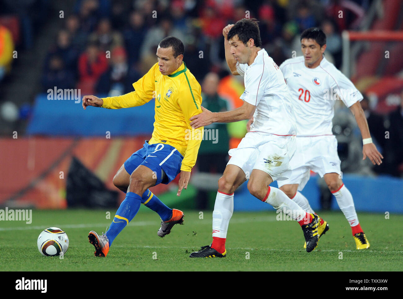 Luis Fabiano of Brazil and Pablo Contreras of Chile during the FIFA World Cup Round of 16 match at Ellis Park in Johannesburg, South Africa on June 28, 2010. UPI/Chris Brunskill Stock Photo