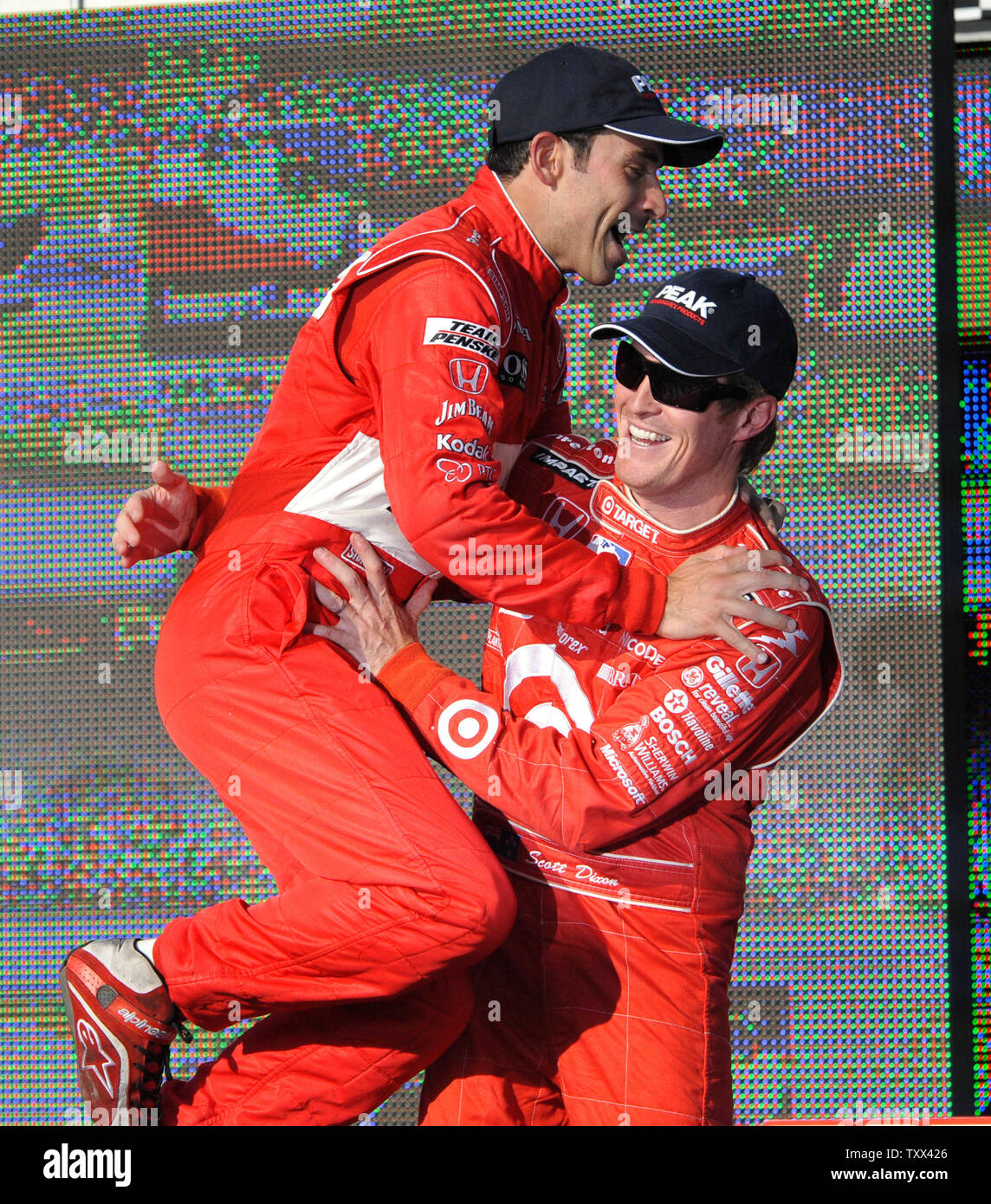 Helio Castroneves, winner of the Peak 300, leaps into the arms of his teammate Ryan Briscoe, who finished third, in the winners circle at the Chicagoland Speedway in Joliet, Illinois on September 7, 2008. (UPI Photo/Darrell Hoemann) Stock Photo