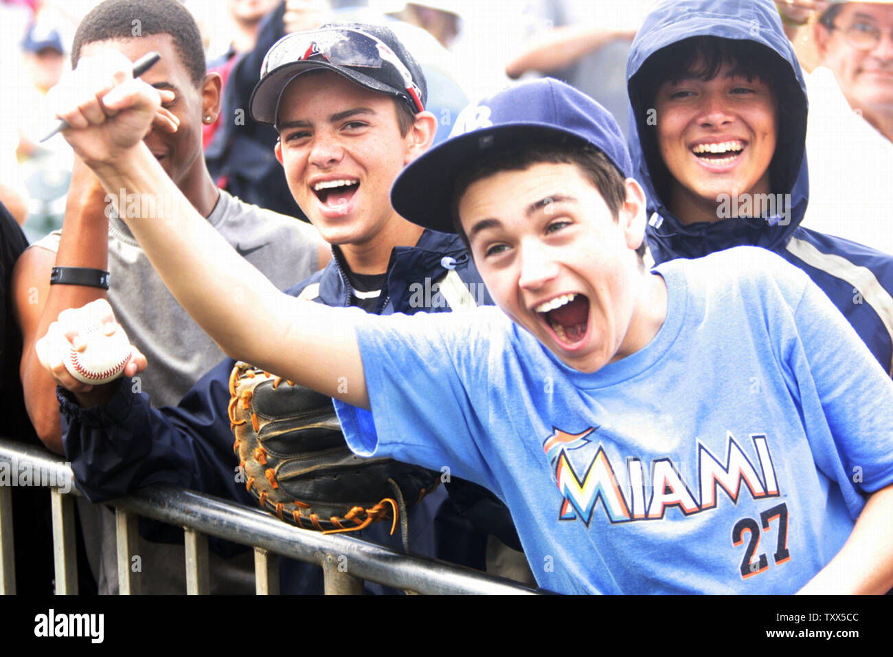 Young fans celebrate a Miami Marlins home run against the New York Mets  during spring training at the Roger Dean Stadium in Jupiter, Florida on  March 15, 2012. The Miami Marlins beat