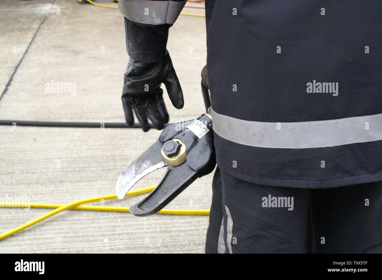 fire fighter using hydraulic cutting equipment, RTC Stock Photo Alamy