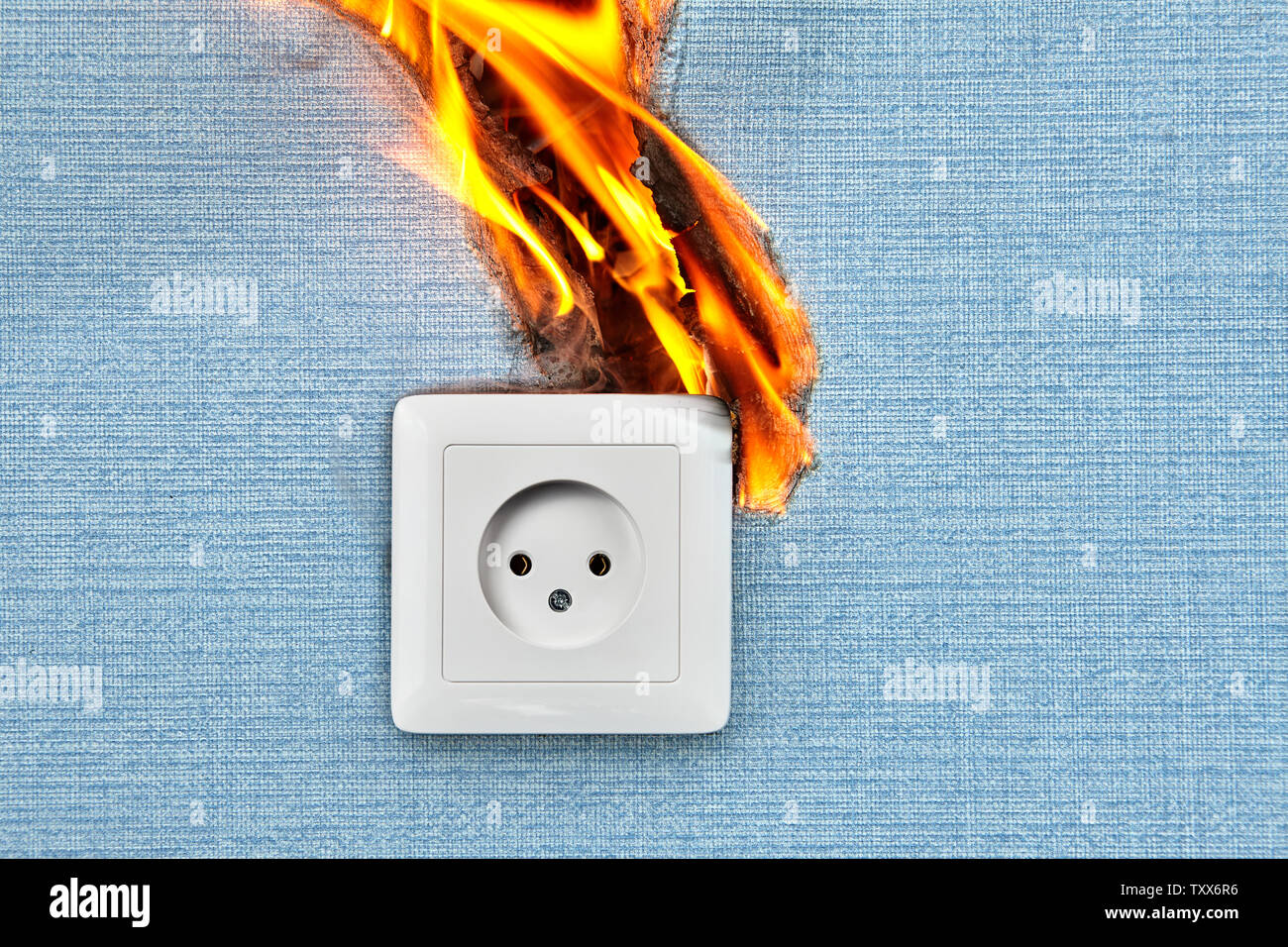 Bad electrical wiring blames in case of fire electric outlet. Faulty wiring causes fires. Stock Photo