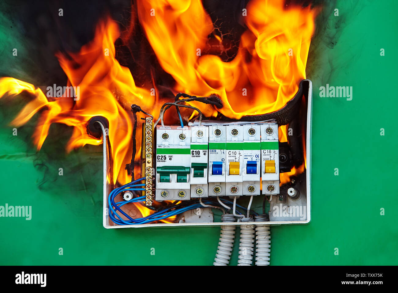 Defect of electrical distribution panel with circuit breaker is the cause of a fire in the apartment. Electrical failures and malfunctions are a facto Stock Photo