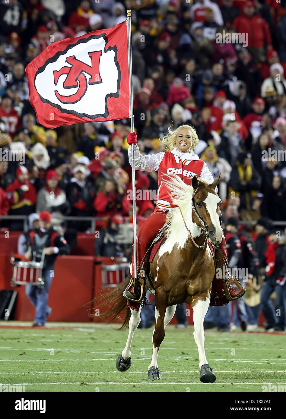Kansas City Chiefs cheerleader rides in on a horse carrying a Chiefs