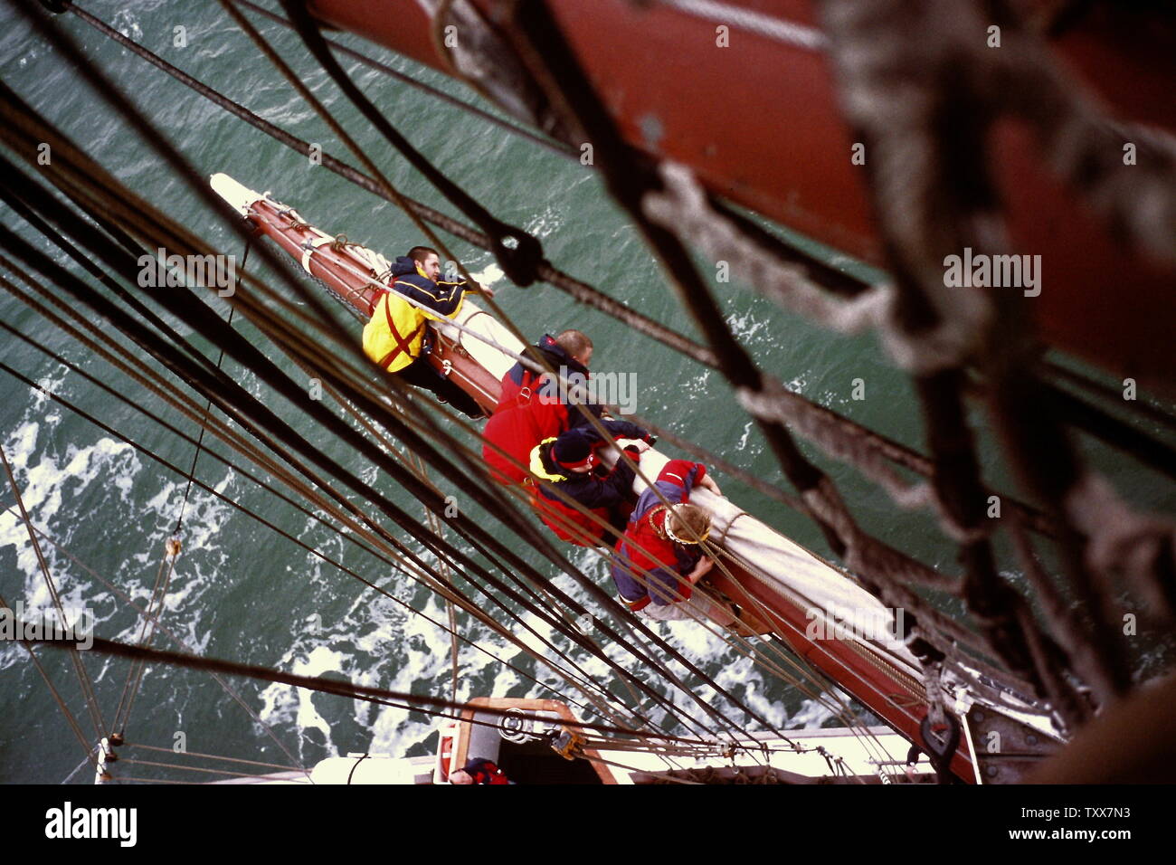 AJAXNETPHOTO. PORTSMOUTH, ENGLAND. - TALL SHIP SAILING - CREW OF THE TALL SHIP PRINCE WILLIAM FURLING SAIL BEFORE ENTERING HARBOUR. PHOTO:JONATHAN EASTLAND/AJAX REF:131208 172 Stock Photo