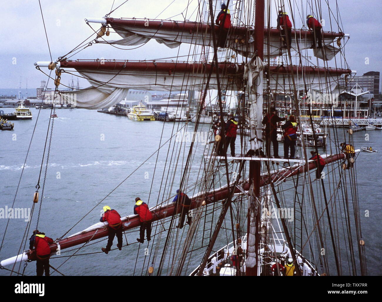 AJAXNETPHOTO. PORTSMOUTH, ENGLAND. - TALL SHIP SAILING - CREW OF THE TALL SHIP PRINCE WILLIAM FURLING SAIL BEFORE ENTERING HARBOUR. PHOTO:JONATHAN EASTLAND/AJAX REF:131208_177 Stock Photo