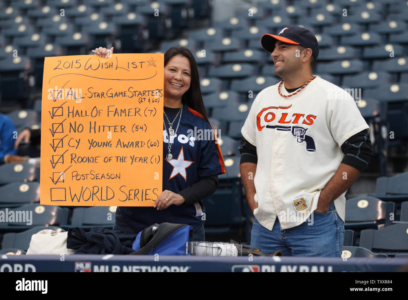 A Houston Astros fan holds up her wish list sign before game 2 of