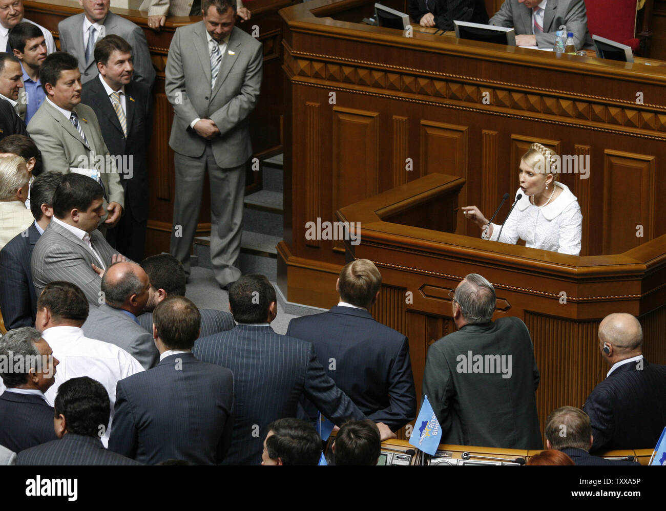 Former Ukrainian Prime Minister Yulia Tymoshenko surrounded by her political rivals addresses parliament in Kiev on July 18, 2006. President Viktor Yushchenko's bloc is going into opposition in the Ukrainian parliament, a top party leader declared Tuesday, suggesting that the party had rebuffed overtures to join a new coalition headed by the president's Orange Revolution rival Viktor Yanukovych. (UPI Photo/Sergey Starostenko) Stock Photo