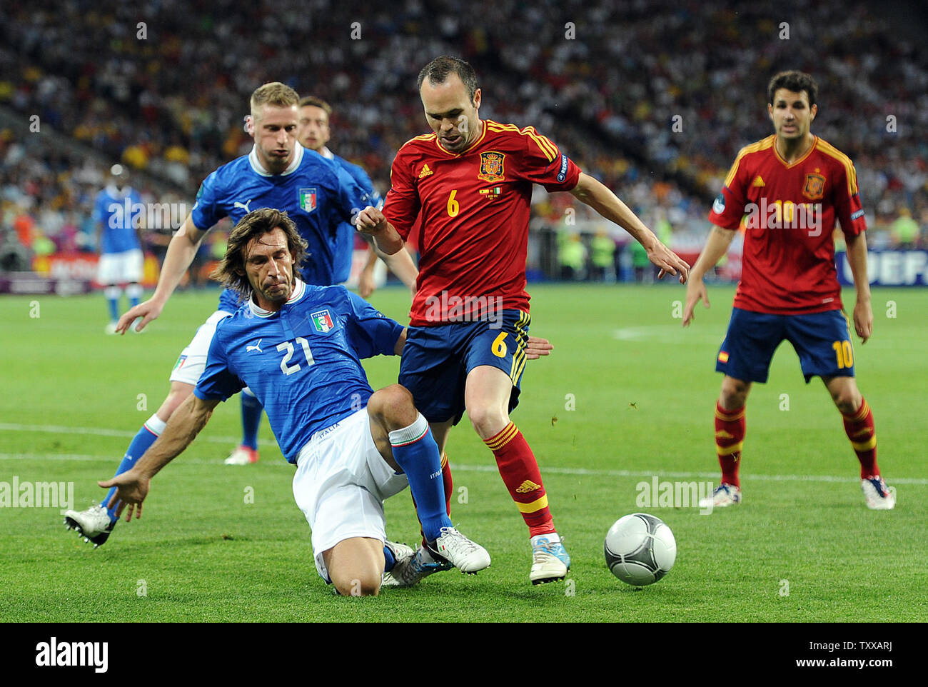 Andres Iniesta (R) of Spain is tackled by Andrea Pirlo of Italy during the Euro 2012 Final match at the Olympic Stadium in Kiev, Ukraine on July 1, 2012. UPI/Chris Brunskill Stock Photo