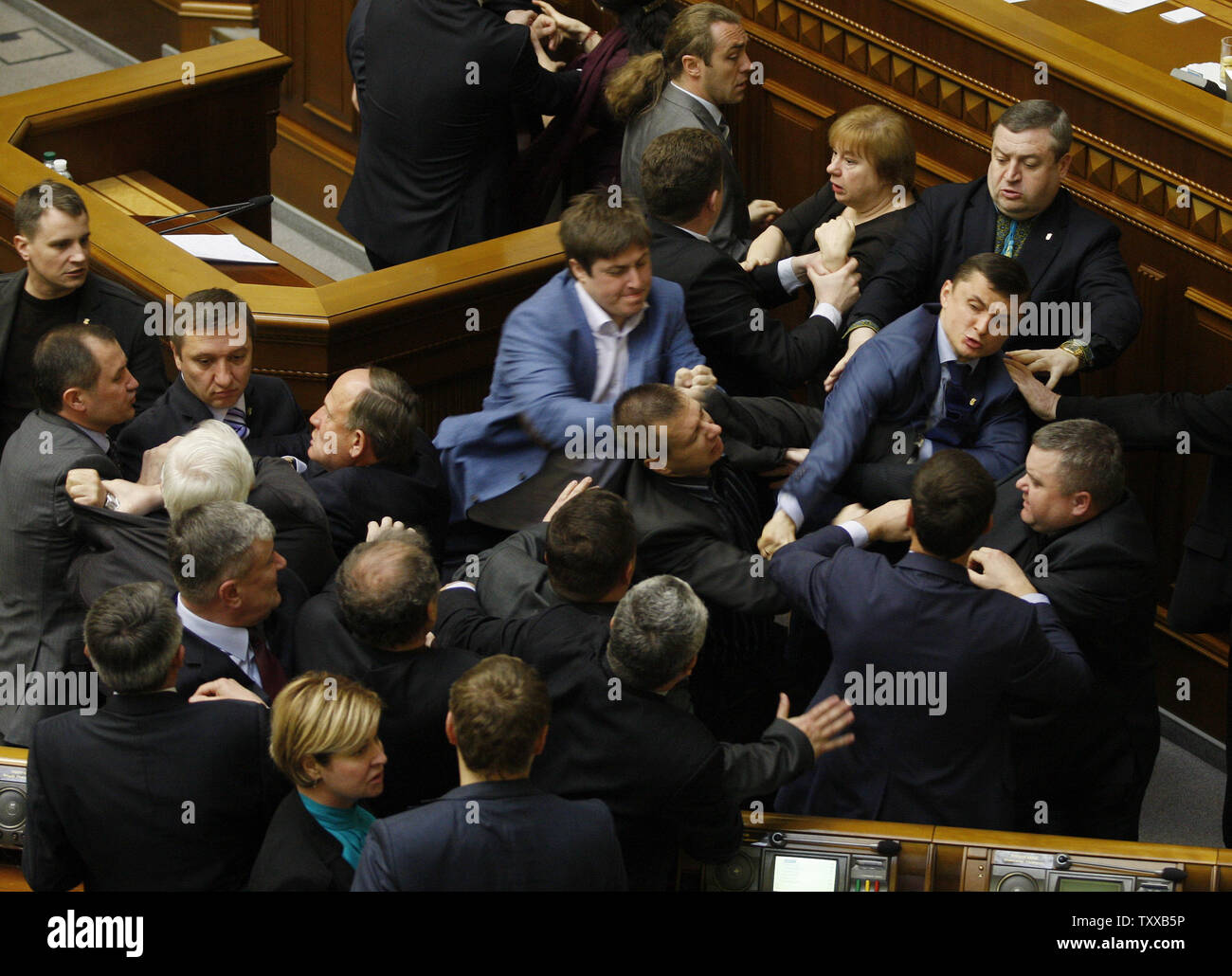 Ukrainian lawmakers from Communist Party and the radical nationalist right-wing Svoboda (Freedom) Party fight during a parliament session in Kiev on April 8, 2014.    The fight was provoked by different opinions on what is causing the unrest in eastern Ukraine.   UPI/Ivan Vakolenko Stock Photo