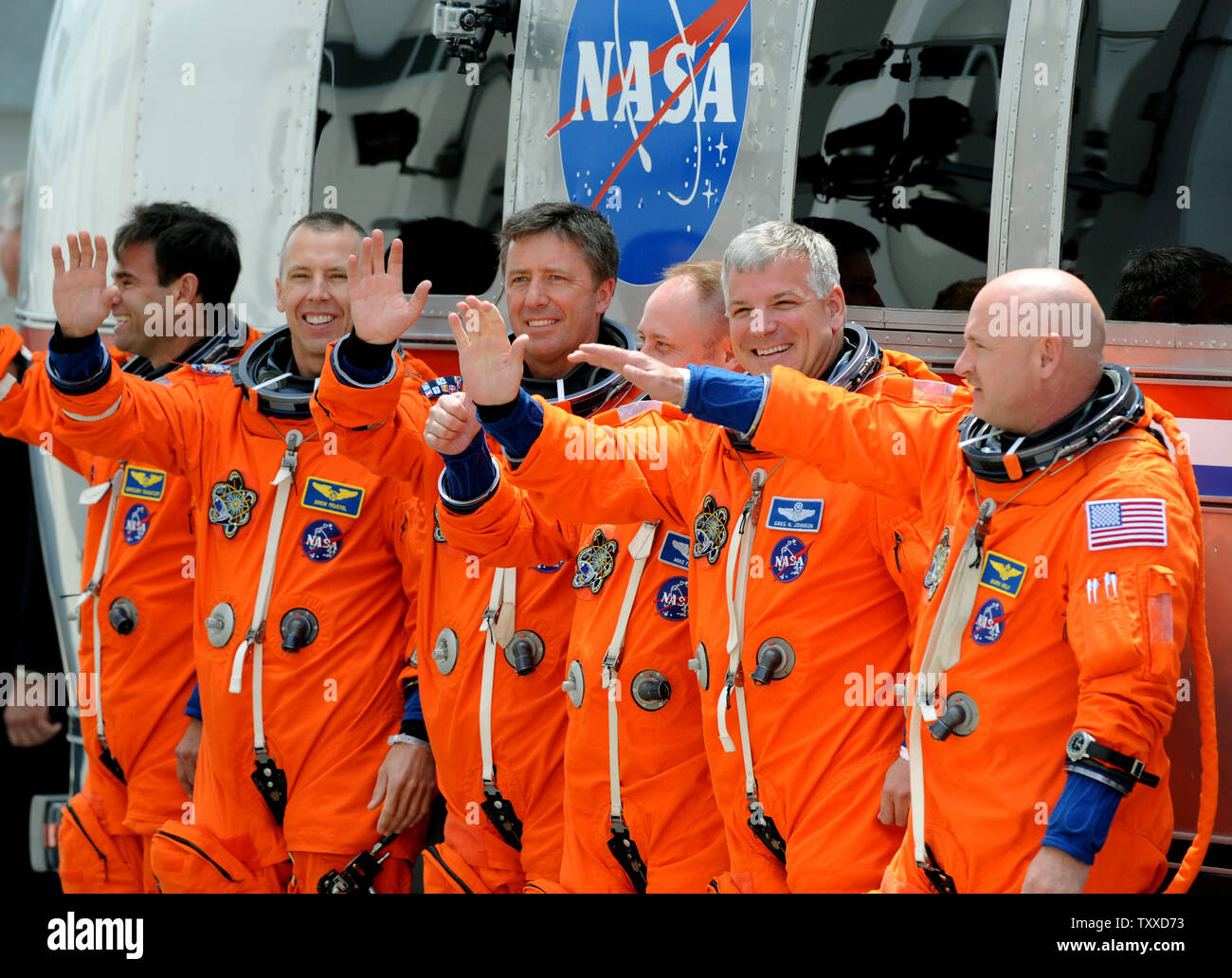 Space Shuttle Endeavour Commander Mark Kelly (right) waves after departing with his crew and boarding the Astrovan on their way to the launchpad for Endeavour's last flight at Kennedy Space Center on April 29, 2011.  The launch attempt was scrubbed minutes later. Behind Kelly is Pilot Greg Johnston and mission specialists  Mike Finke and Roberto Vittori, Drew Feustel, and Greg Chamitoff (left).  Kelly is the husband of Arizona Congresswoman Gabrielle Giffords, who was recovering from an assassination attempt and at the Cape to watch the possible liftoff.   UPI/ Pat Benic Stock Photo