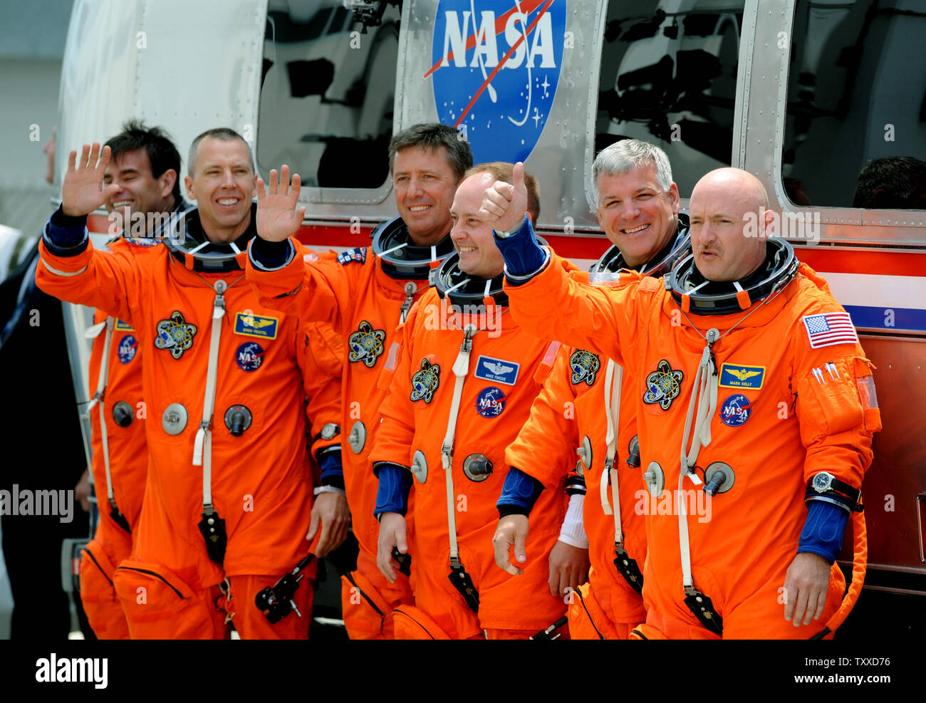 Space Shuttle Endeavour Commander Mark Kelly (right) gives the thumbs up after departing with his crew and boarding the Astrovan on their way to the launchpad for Endeavour's last flight at Kennedy Space Center on April 29, 2011.  The launch attempt was scrubbed minutes later. Behind Kelly is Pilot Greg Johnston and mission specialists  Mike Finke and Roberto Vittori, Drew Feustel, and Greg Chamitoff (left).  Kelly is the husband of Arizona Congresswoman Gabrielle Giffords, who was recovering from an assassination attempt and at the Cape to watch the possible liftoff.   UPI/ Pat Benic Stock Photo
