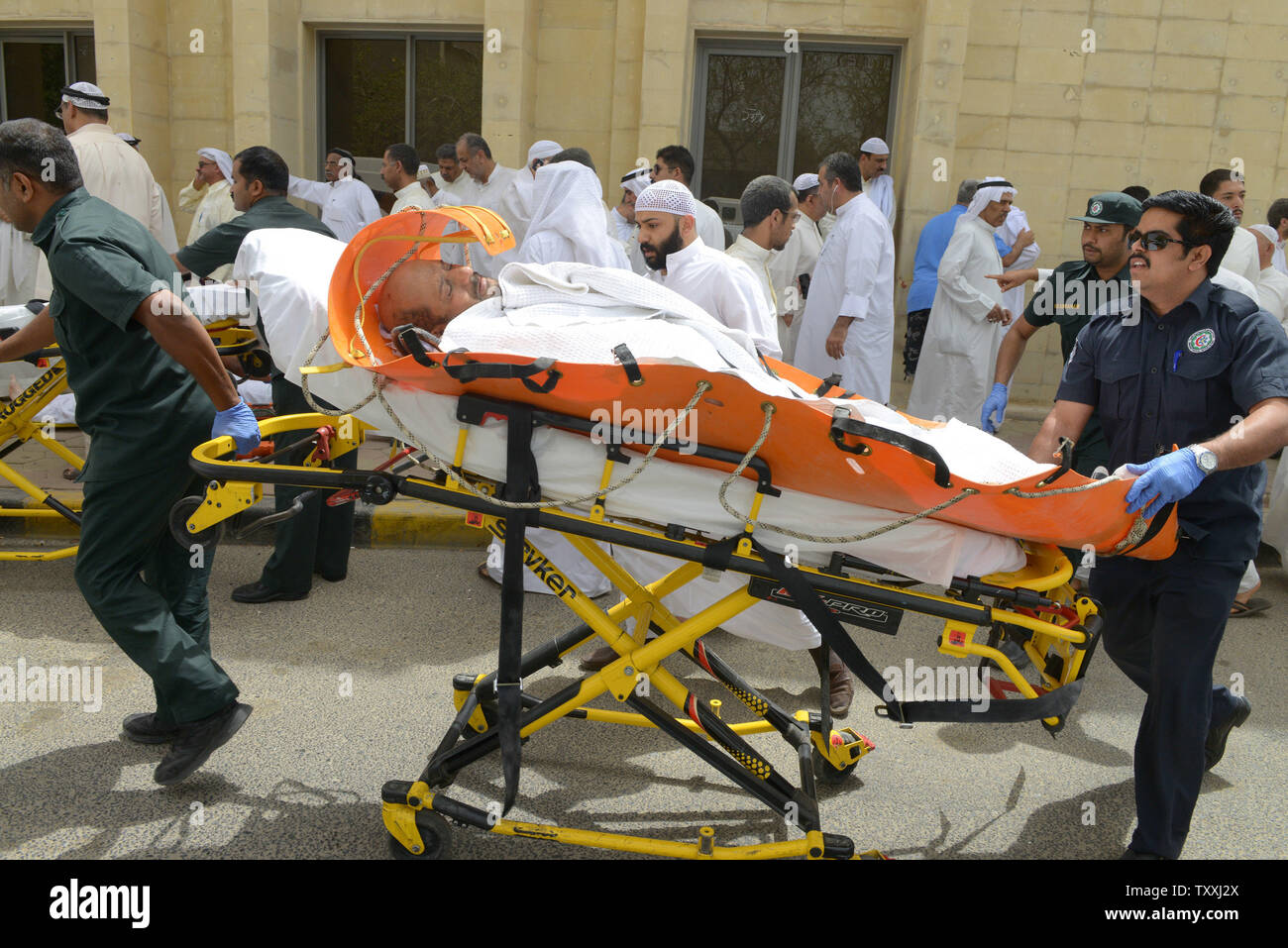 Kuwaitis help a wounded man at the Imam Sadiq Mosque after a deadly explosion claimed by the Islamic State group during Friday prayers in Kuwait City, Friday, June 26, 2015. At least 25 people have been killed and 202 others wounded when a suicide bomber targeted the Friday prayers at a Shia mosque in Kuwait City, Kuwaiti medical sources and human rights activists said. Photo by Raed Qutena/UPI Stock Photo