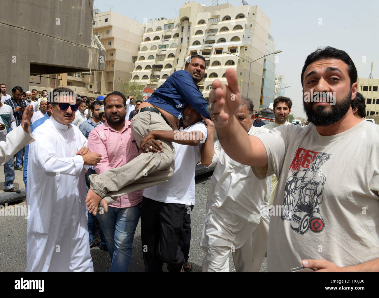 Kuwaitis help a wounded man at the Imam Sadiq Mosque after a deadly explosion claimed by the Islamic State group during Friday prayers in Kuwait City, June 26, 2015. At least 25 people were killed and 202 others wounded when a suicide bomber targeted the Friday prayers at a Shia mosque in Kuwait City medical sources and human rights activists said. Photo by Raed Qutena/UPI Stock Photo