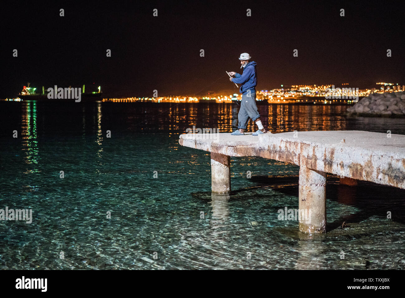 Fisherman at night, Aqaba, Jordan Stock Photo